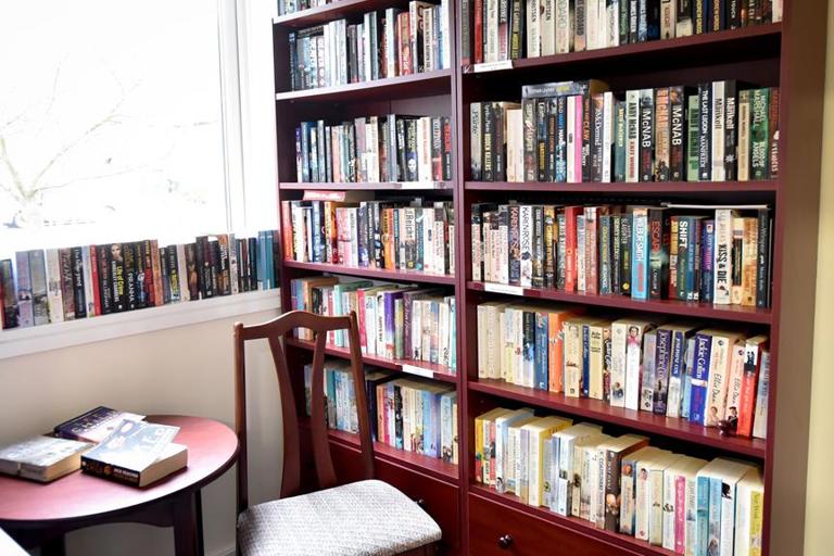 Large bookshelf in the communal library at Alan Hilton Court