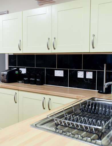 Communal kitchen with sink, toaster and stylish worktops and tiling