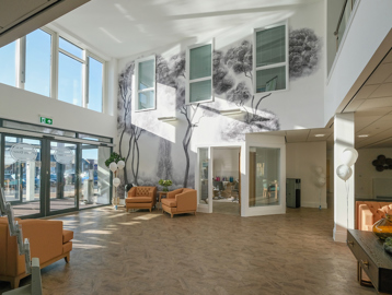 Entrance area to Poppy Dene with soft seating and tables in the foyer