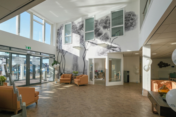 Entrance area to Poppy Dene with soft seating and tables in the foyer