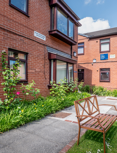 William Griffiths Court External bench and seating area with green gardens 