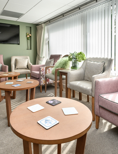 Sunny communal lounge with modern furniture 