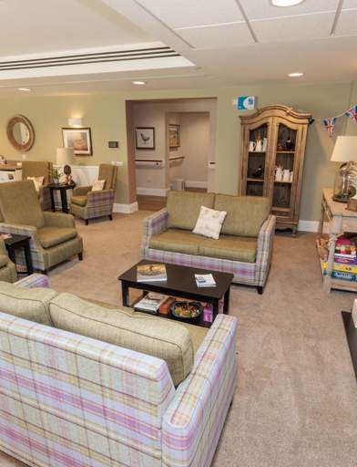 An image showing inside Bowland View's communal lounge with sofa's, chairs and coffee tables