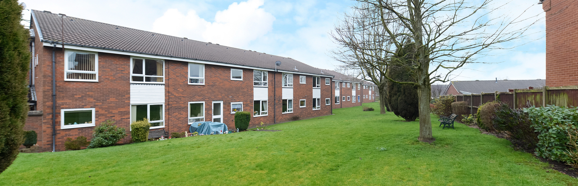 External photo of the main building of Smalley Court surrounded by large grass area