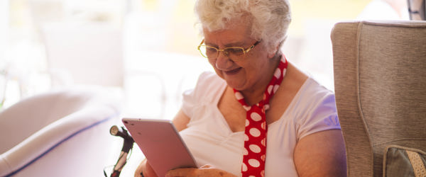 Caucasian lady sitting reading on her mobile phone