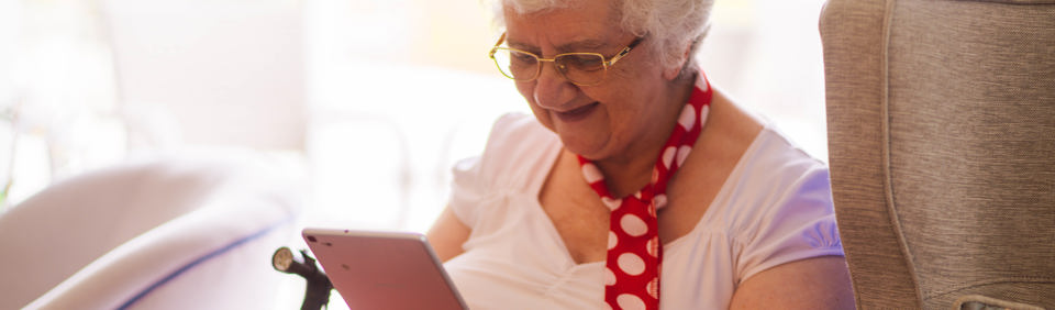Caucasian lady sitting reading on her mobile phone 