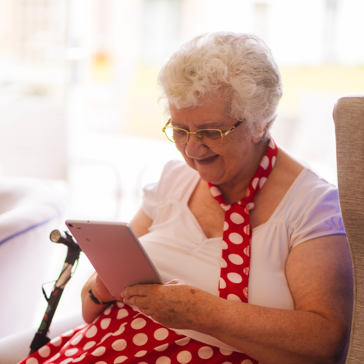 Caucasian lady sitting reading on her mobile phone