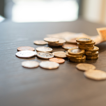 A collection of British monetary coins and notes on a table 