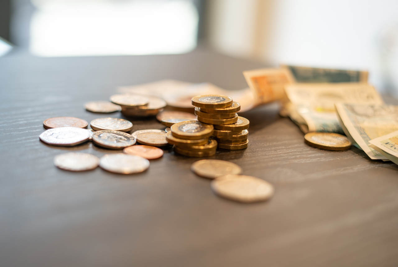 A collection of British monetary coins and notes on a table 