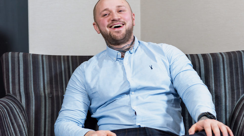 A Housing 21 employee laughing whilst sitting in a chair
