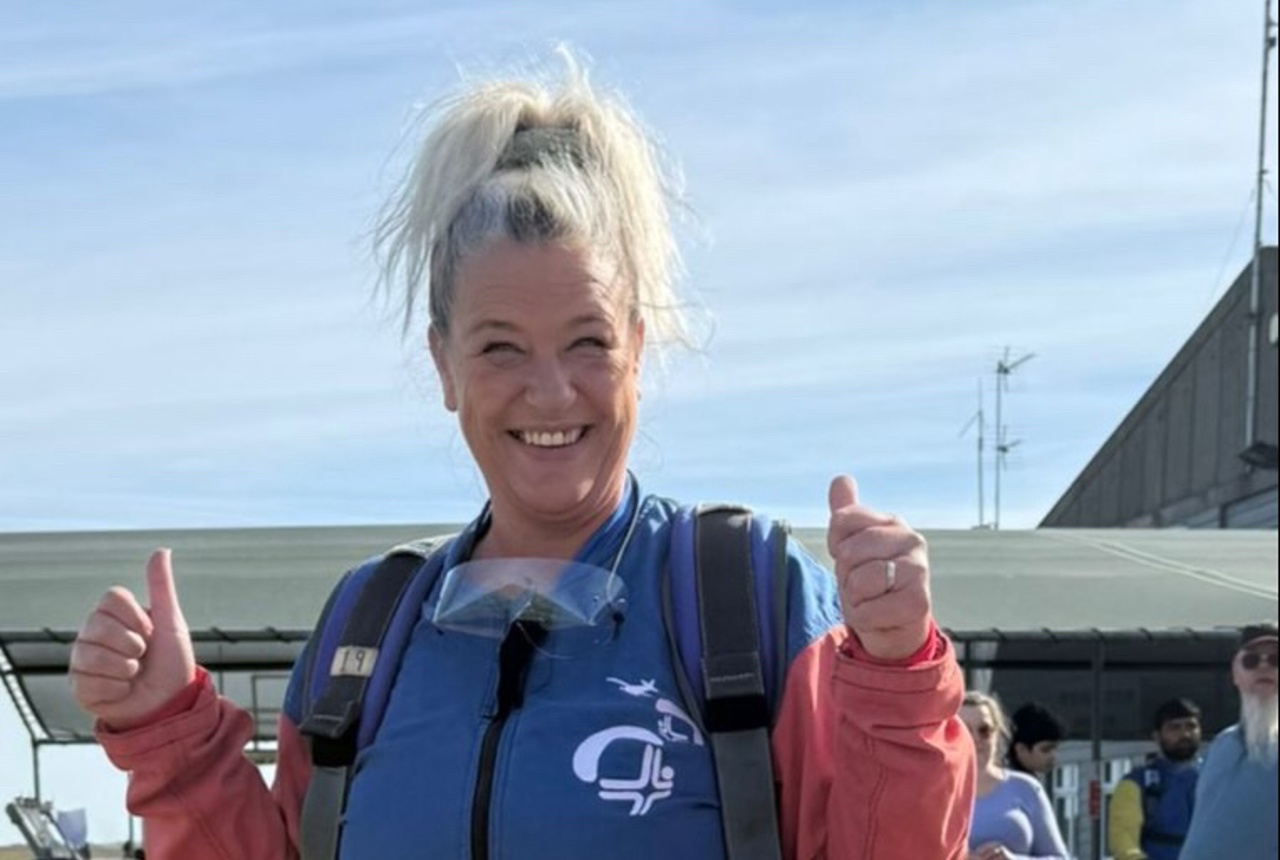 A woman gives a thumbs up ahead of taking part in a skydive