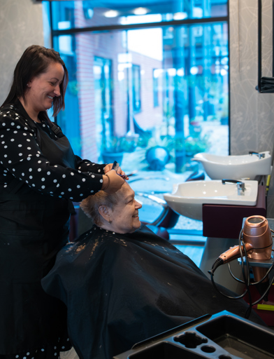 A resident enjoying her visit to the on-site salon at Lime Gardens 