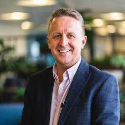 Kris Peach, Managing Director of Extra Care, smiles into the camera