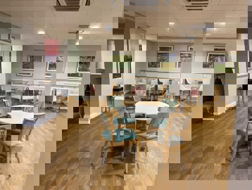 Four chairs around a table in a communal area
