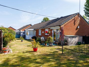 The exterior of a property at Pakefield Court with a bungalow, garden, fencing and plants