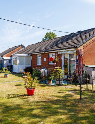 The exterior of a property at Pakefield Court with a bungalow, garden, fencing and plants 