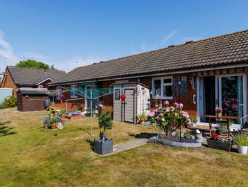 The exterior of a property at Pakefield Court with a bungalow, garden, fencing and plants