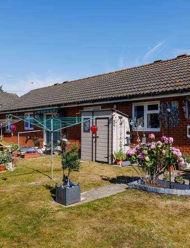The exterior of a property at Pakefield Court with a bungalow, garden, fencing and plants 
