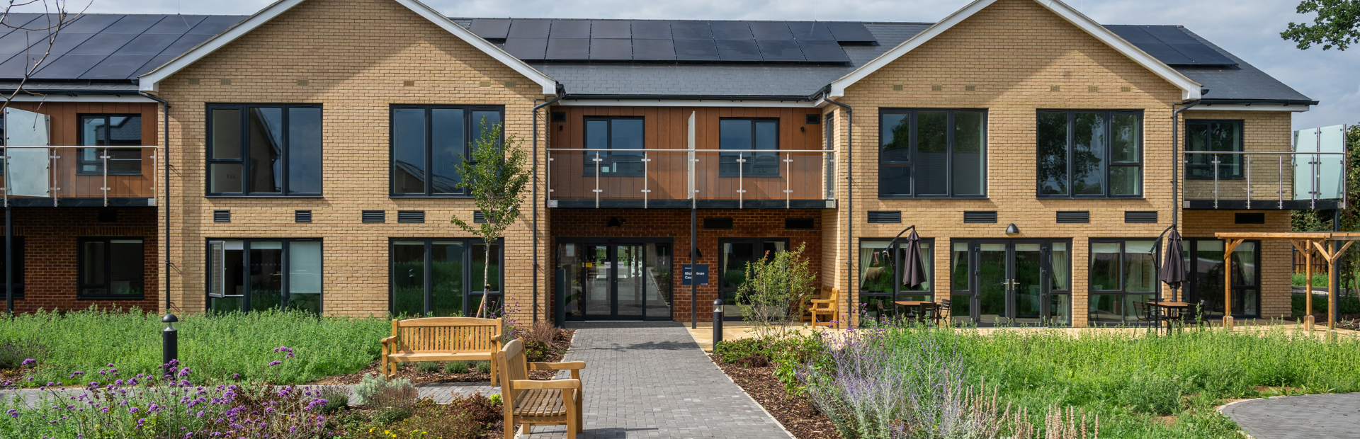 Outer building of Michaelmas Court surrounded by greenery 