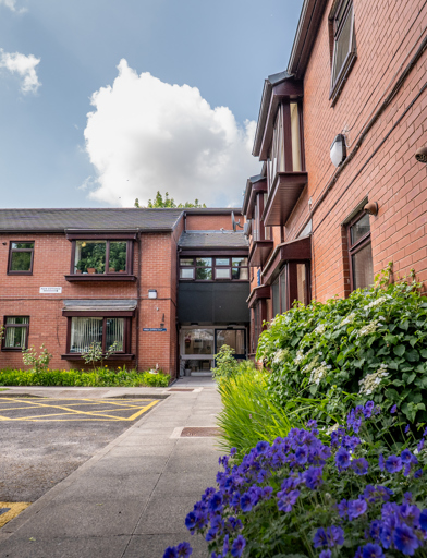 William Griffiths Court External purple flowers and the front doors to the scheme 