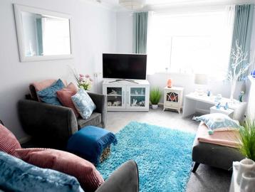 A bright and cosy living room in an apartment at Goodman Court