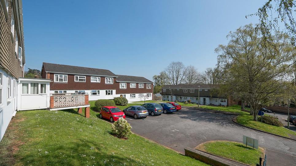 Car park and grassed area to the outside of the scheme