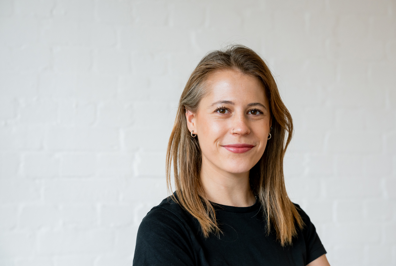 A woman smiles at the camera