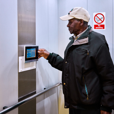 Resident in a lift using touch screen device 