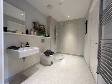 Wet room bathroom at Askern Vale featuring a toilet, walk in shower and sink 