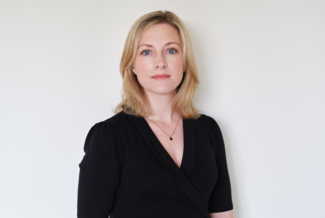 A woman looks into the camera