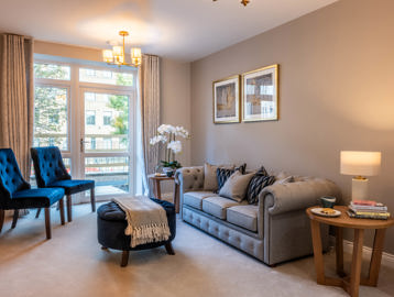 Inside the show home living area with large sofa and coffee table