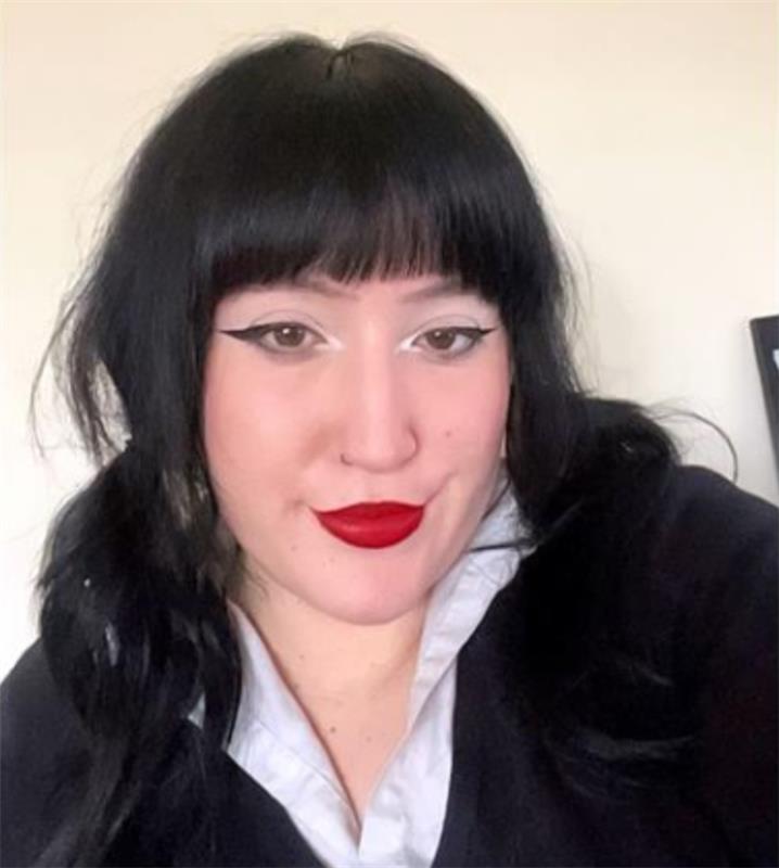 Dark haired young female wears red lipstick