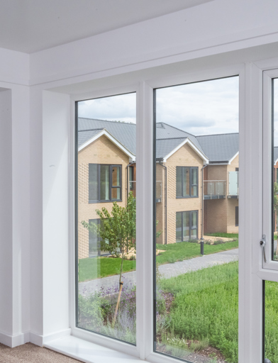 Inside the show home looking through large first floor windows into the communal gardens 