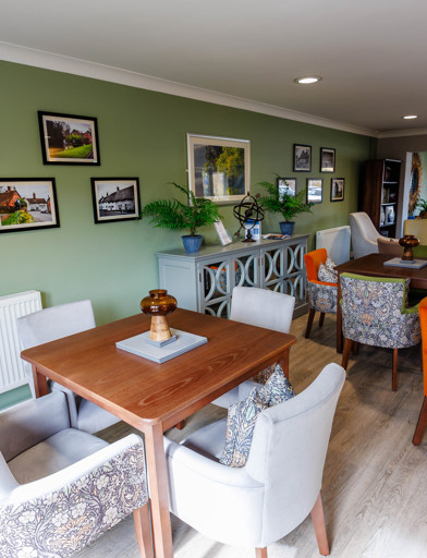 A modern and refurbished dining area with tables and chairs in a kitchen 