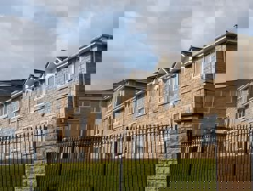 Photograph from the fence looking up at the side of the building