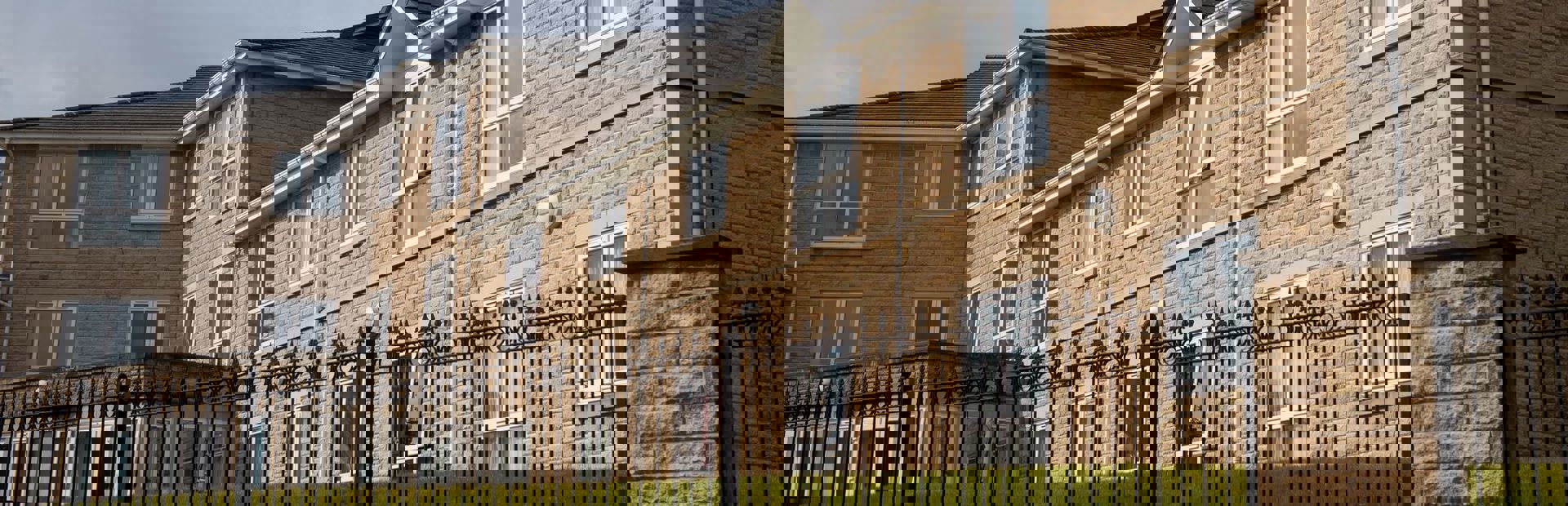 Photograph from the fence looking up at the side of the building