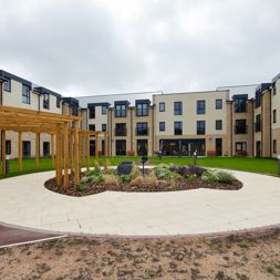 Large communal garden area with plants and large circular patio area in the centre