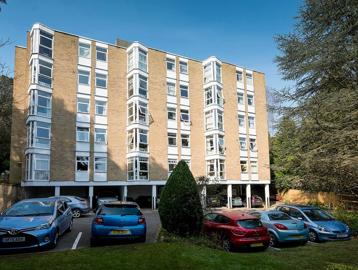 Car park and grassed area to the outside of the scheme