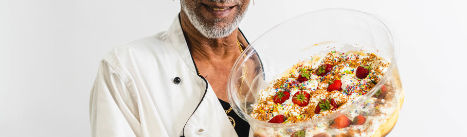Resident holding a cake 