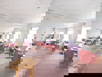Communal lounge area with soft seating and coffee tables