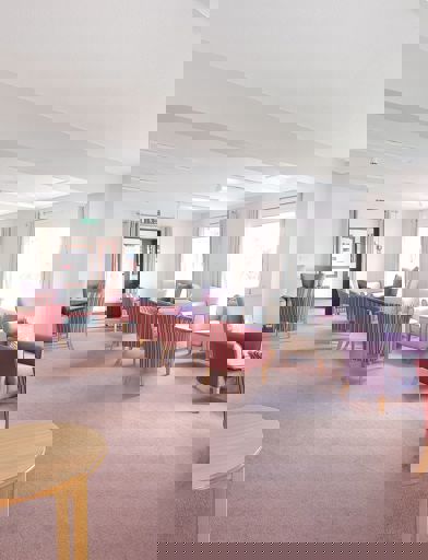 Communal lounge area with soft seating and coffee tables