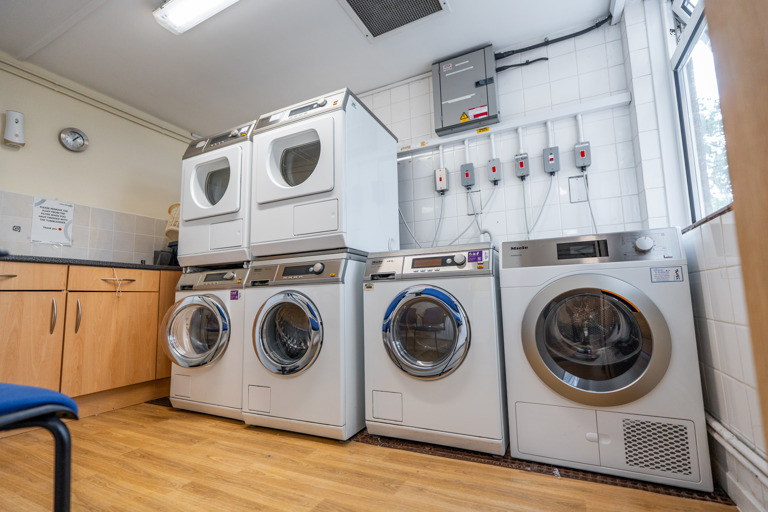 A laundry room with white goods