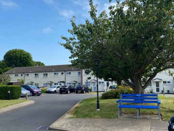 Car park and grassed area to the outside of the scheme