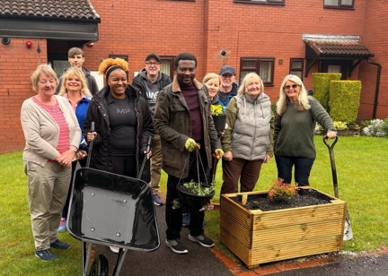 Group of people who have been gardening in cloudy Manchester