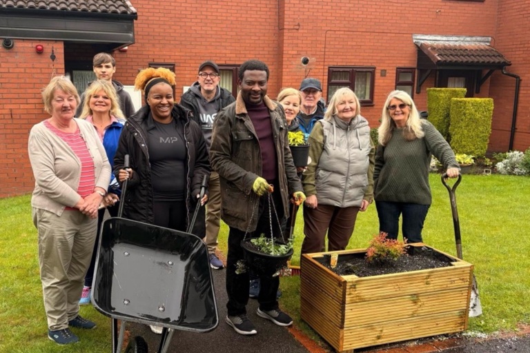 Group of people who have been gardening in cloudy Manchester