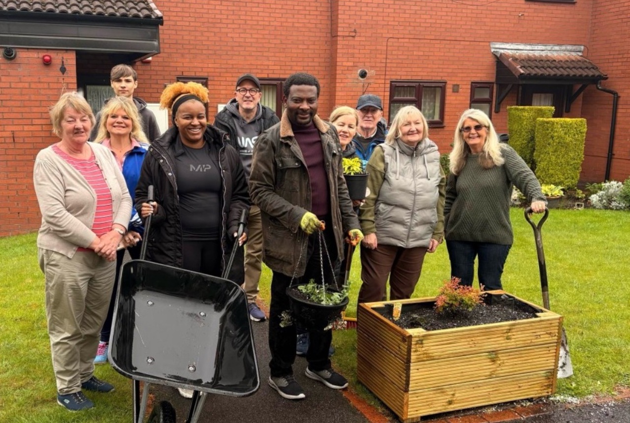 Group of people who have been gardening in cloudy Manchester
