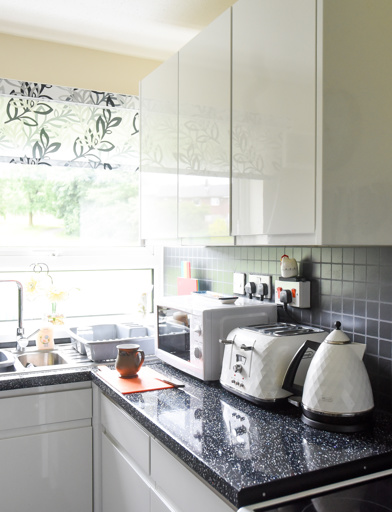 Inside the kitchen of an apartment with utensils and small appliances on show