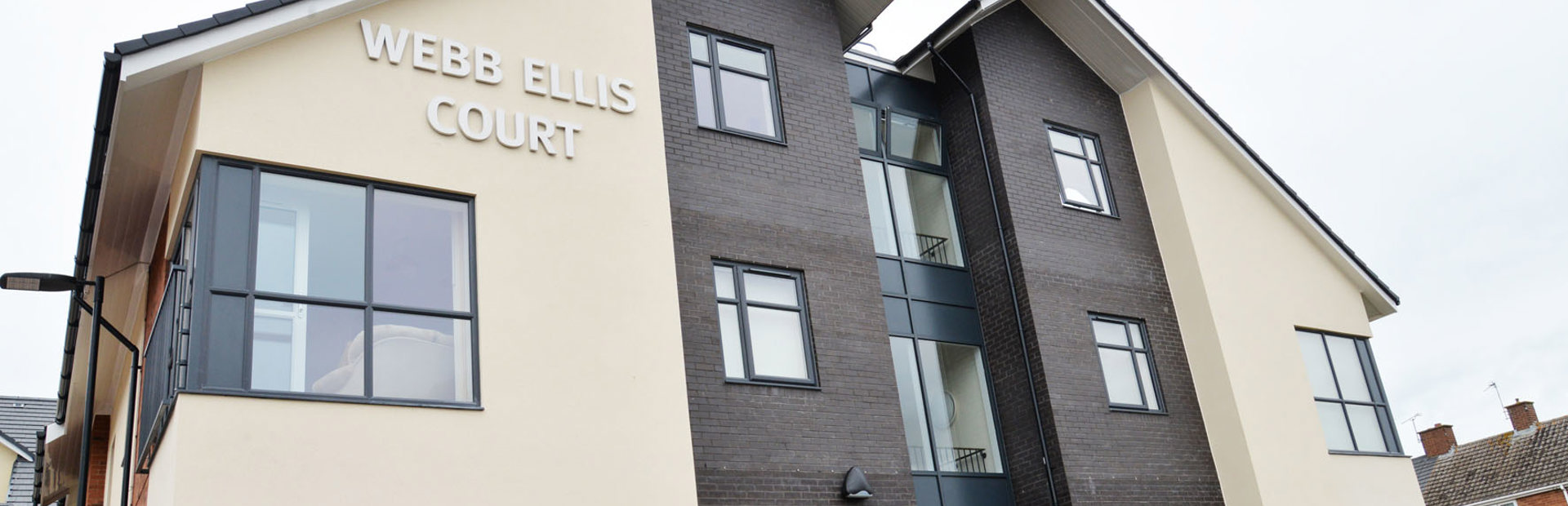 Large sign on the side of the building entrance to Webb Ellis Court
