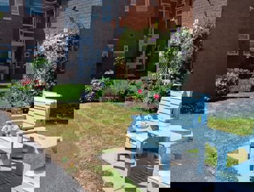 Entrance to the scheme, outside there is a bench seating area painted blue