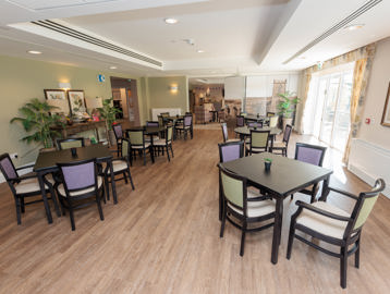 Inside the restaurant at Bowland View. Featuring a number of chairs around tables 